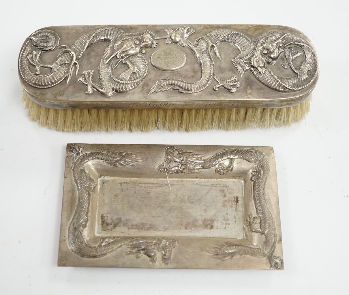 A Chinese white metal brush inscribed 'Presented by the Hokow Foreign Outdoor Staff 1911' and a similar small trinket dish. Condition - fair